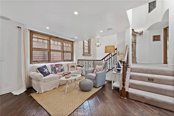 a spacious bedroom with a bed and wooden floor