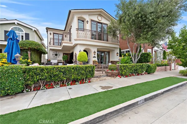 a front view of a house with a garden and plants