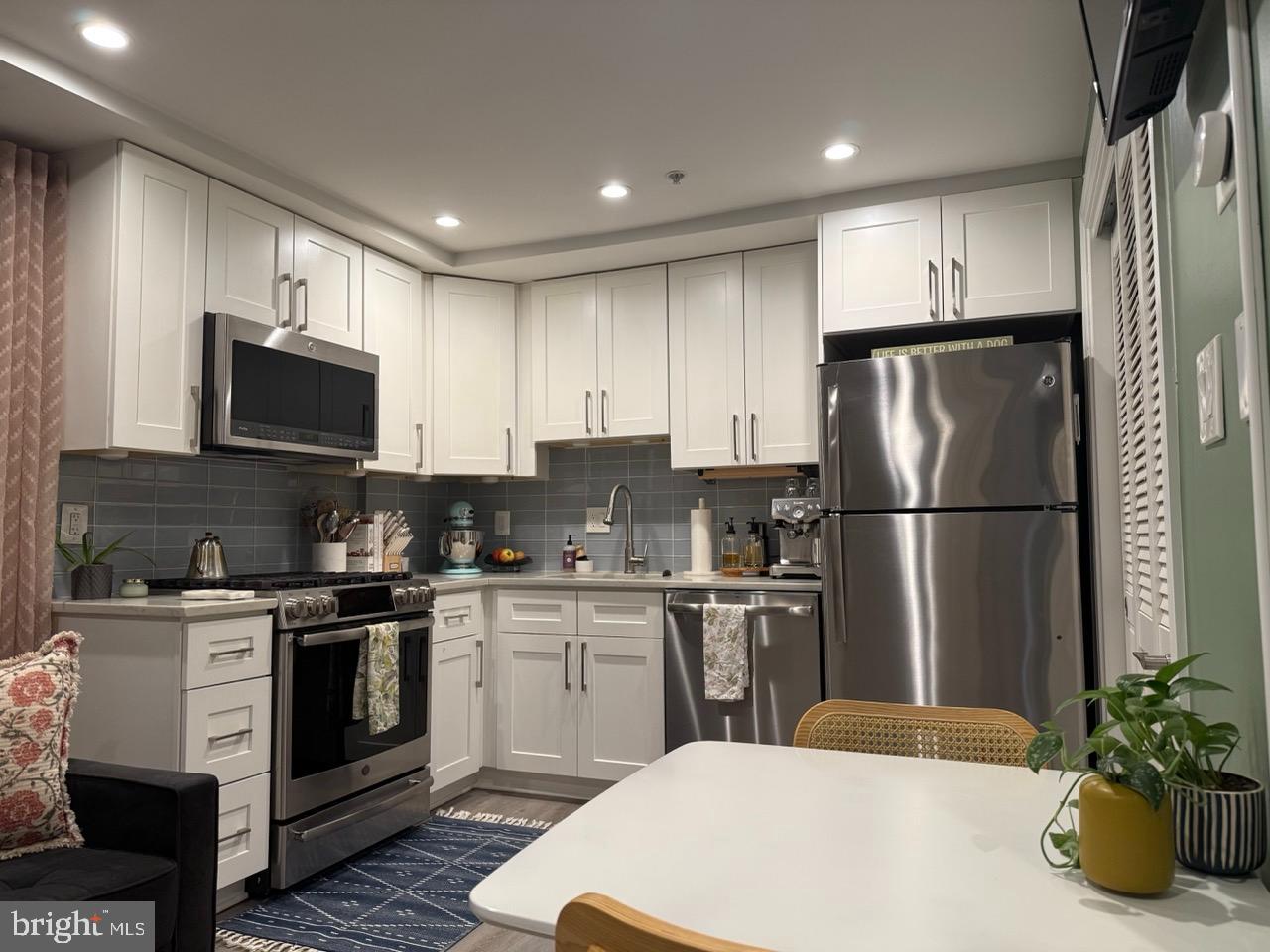 Modern kitchen with sleek white cabinetry.