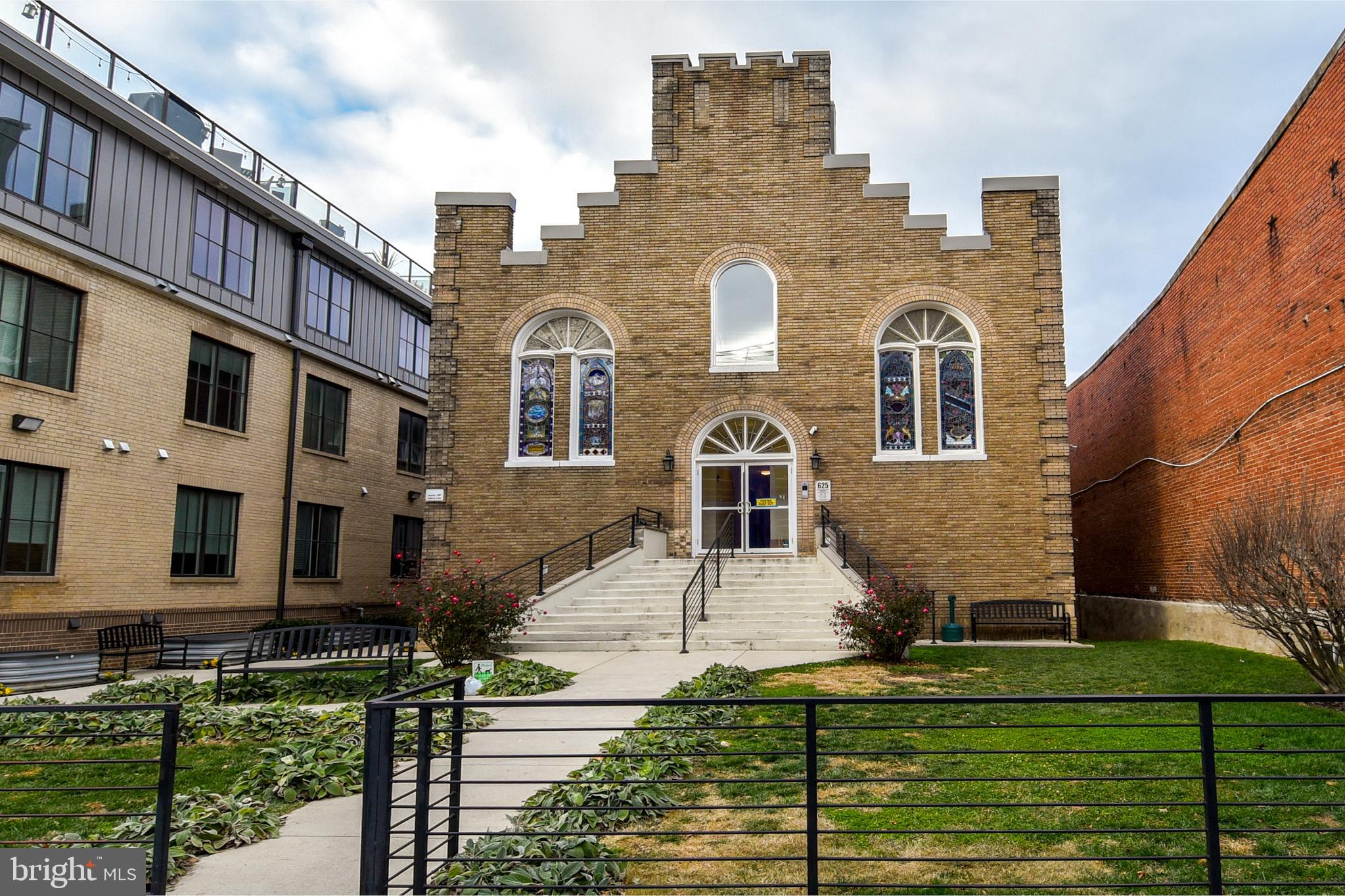 a front view of a residential apartment building with a yard