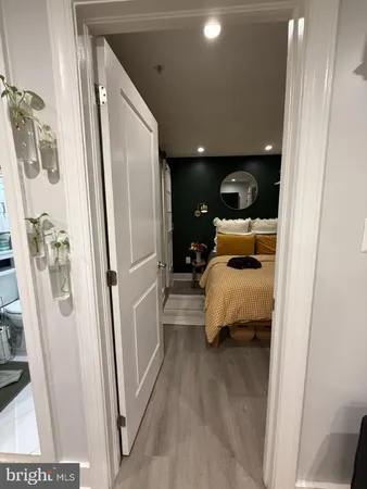a walk in closet with view of bathroom