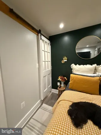 a bedroom with a bed and a mirror