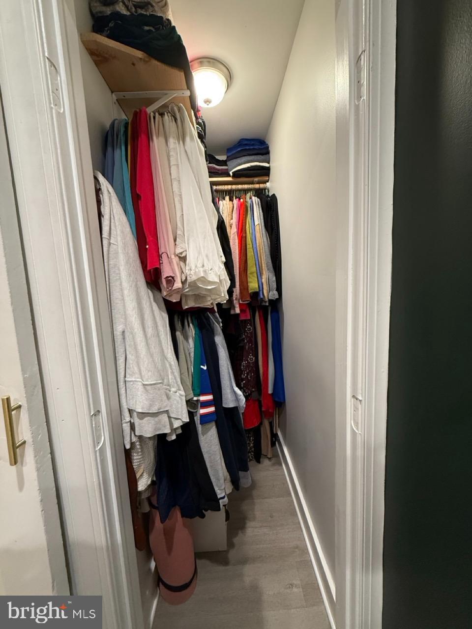 625 Park Road Northwest, Unit C8 Washington, DC 20010 - Photo 23 of 35 Organized closet with vibrant clothing display.