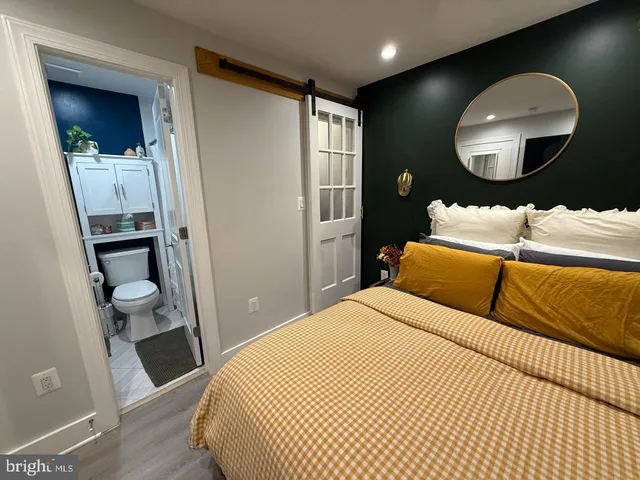 a bedroom with a bed and a mirror