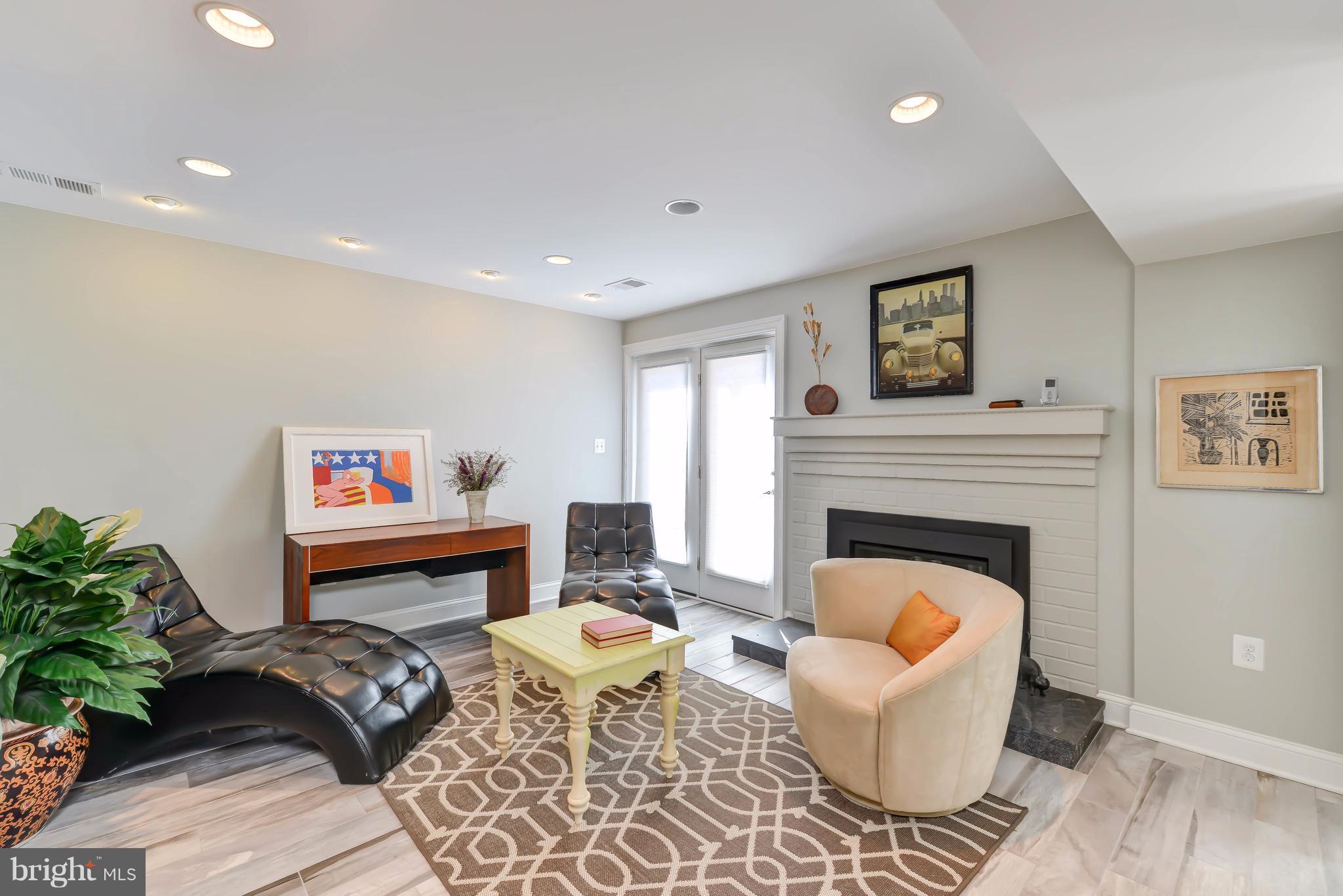 2126 Military Road Arlington, VA 22207 - Photo 5 of 29 a living room with furniture a rug and a fireplace