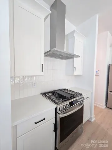 a stove top oven sitting inside of a kitchen