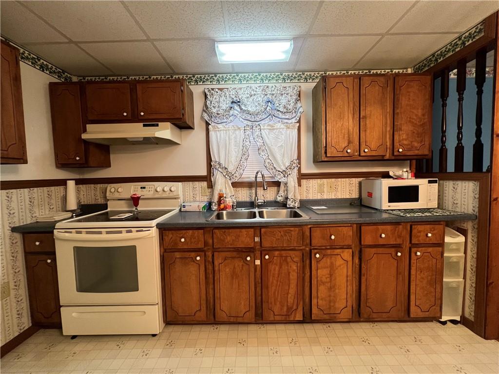 221 Expedite Road Twin Rocks, PA 15960 - Photo 11 of 27 a kitchen with a stove top oven sink and cabinets