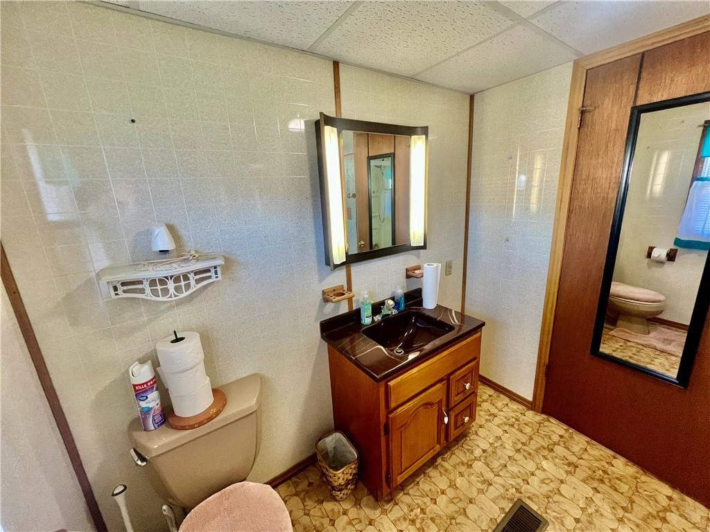 221 Expedite Road Twin Rocks, PA 15960 - Photo 17 of 27 a bathroom with a toilet sink and mirror