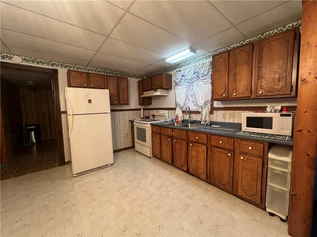 a kitchen with a stove top oven sink and cabinets