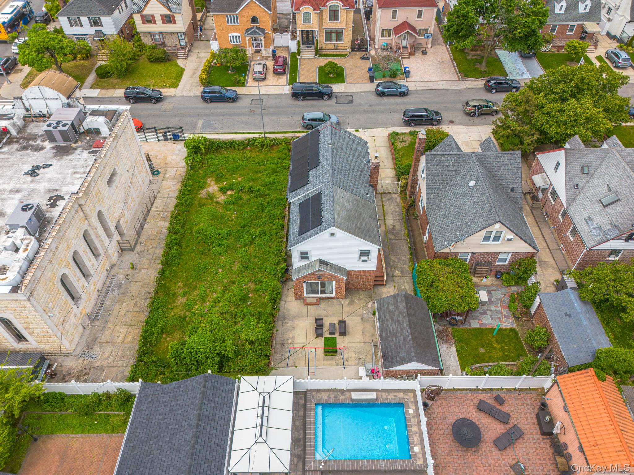 75-75 180th Street Queens, NY 11366 - Photo 2 of 48 an aerial view of multiple houses with yard