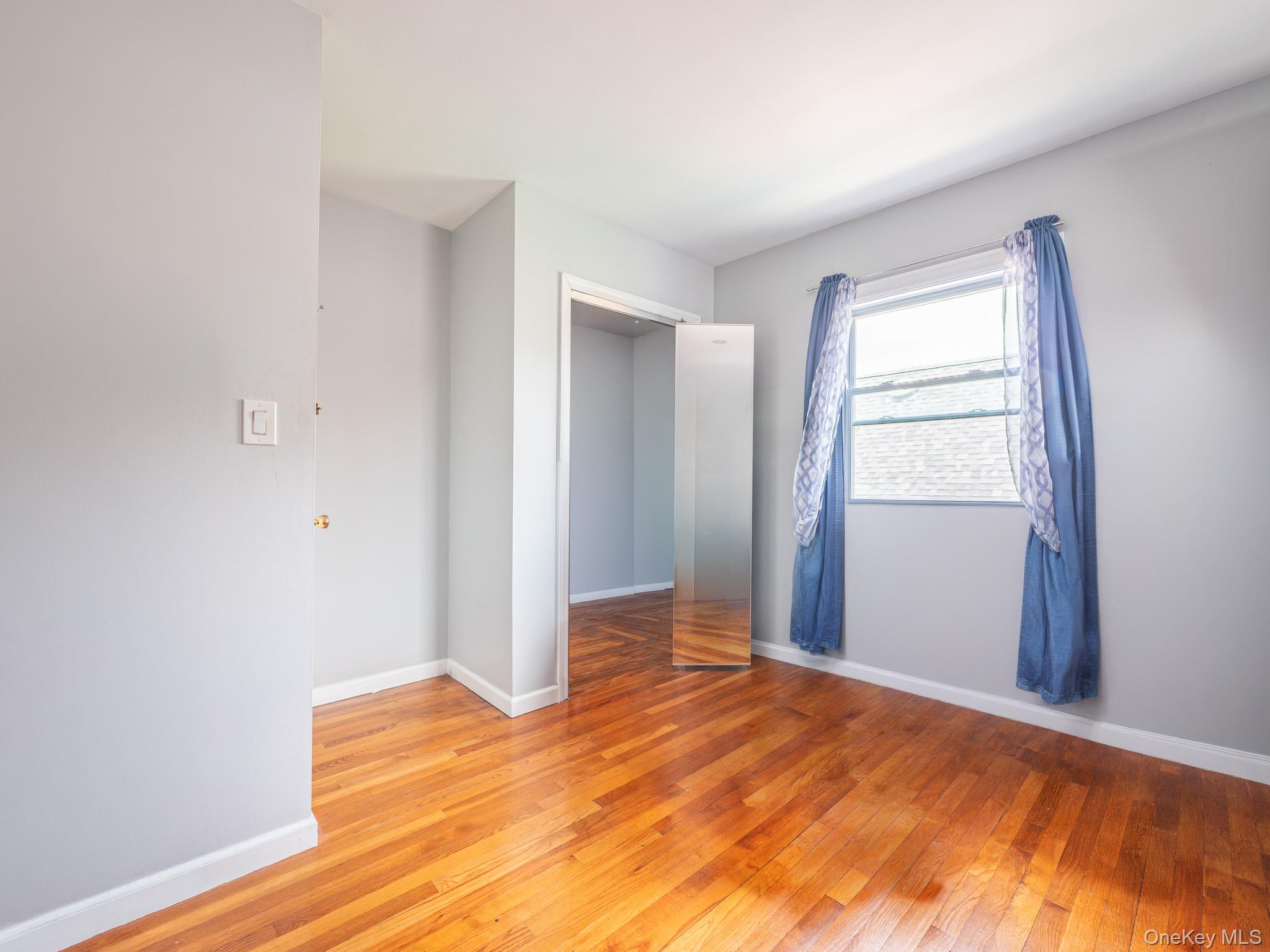 75-75 180th Street Queens, NY 11366 - Photo 23 of 48 a view of empty room with wooden floor