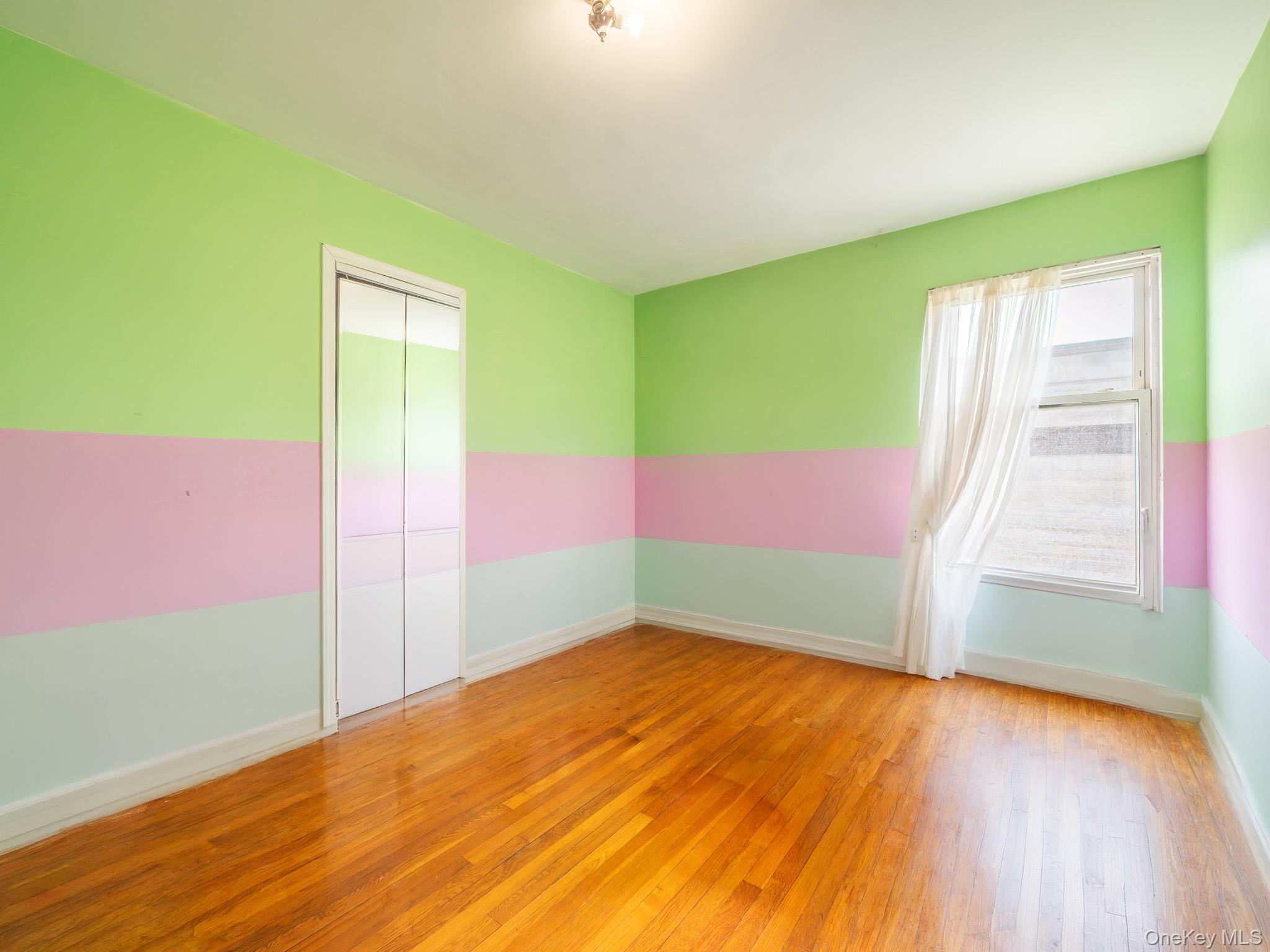 75-75 180th Street Queens, NY 11366 - Photo 25 of 48 a view of an empty room and window