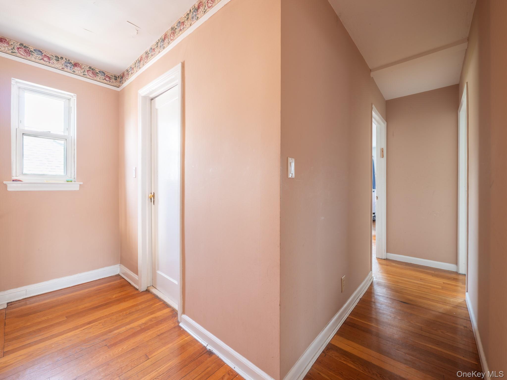 75-75 180th Street Queens, NY 11366 - Photo 30 of 48 a view of room with window and wooden floor