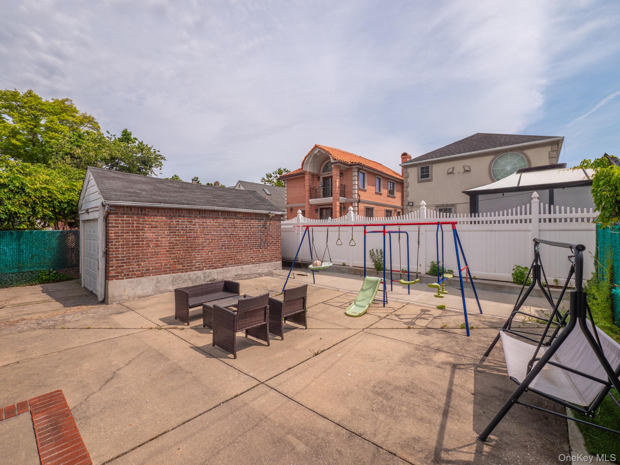 75-75 180th Street Queens, NY 11366 - Photo 38 of 48 a view of a patio with table and chairs and potted plants