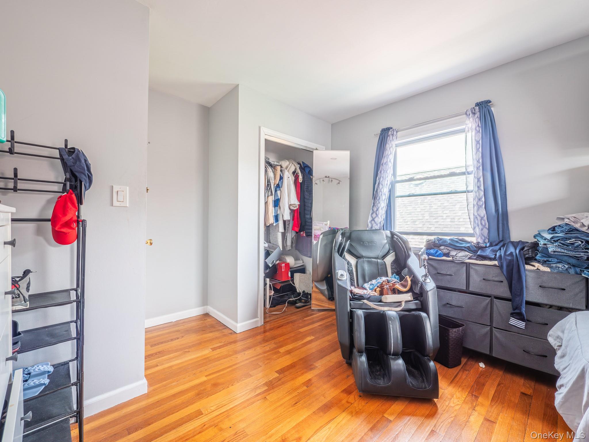 75-75 180th Street Queens, NY 11366 - Photo 44 of 48 a living room with furniture window and a wooden floor