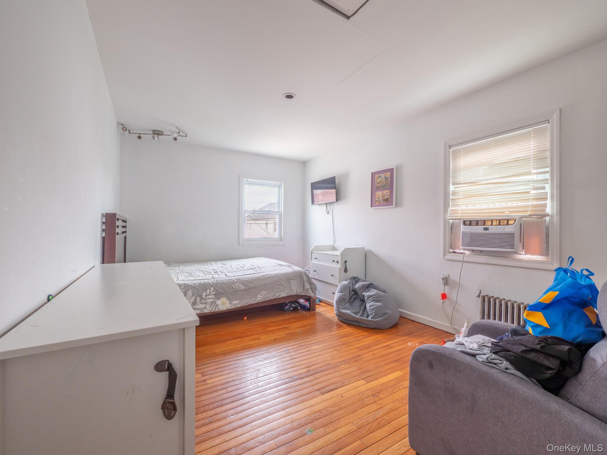 75-75 180th Street Queens, NY 11366 - Photo 45 of 48 a bedroom with furniture and a window