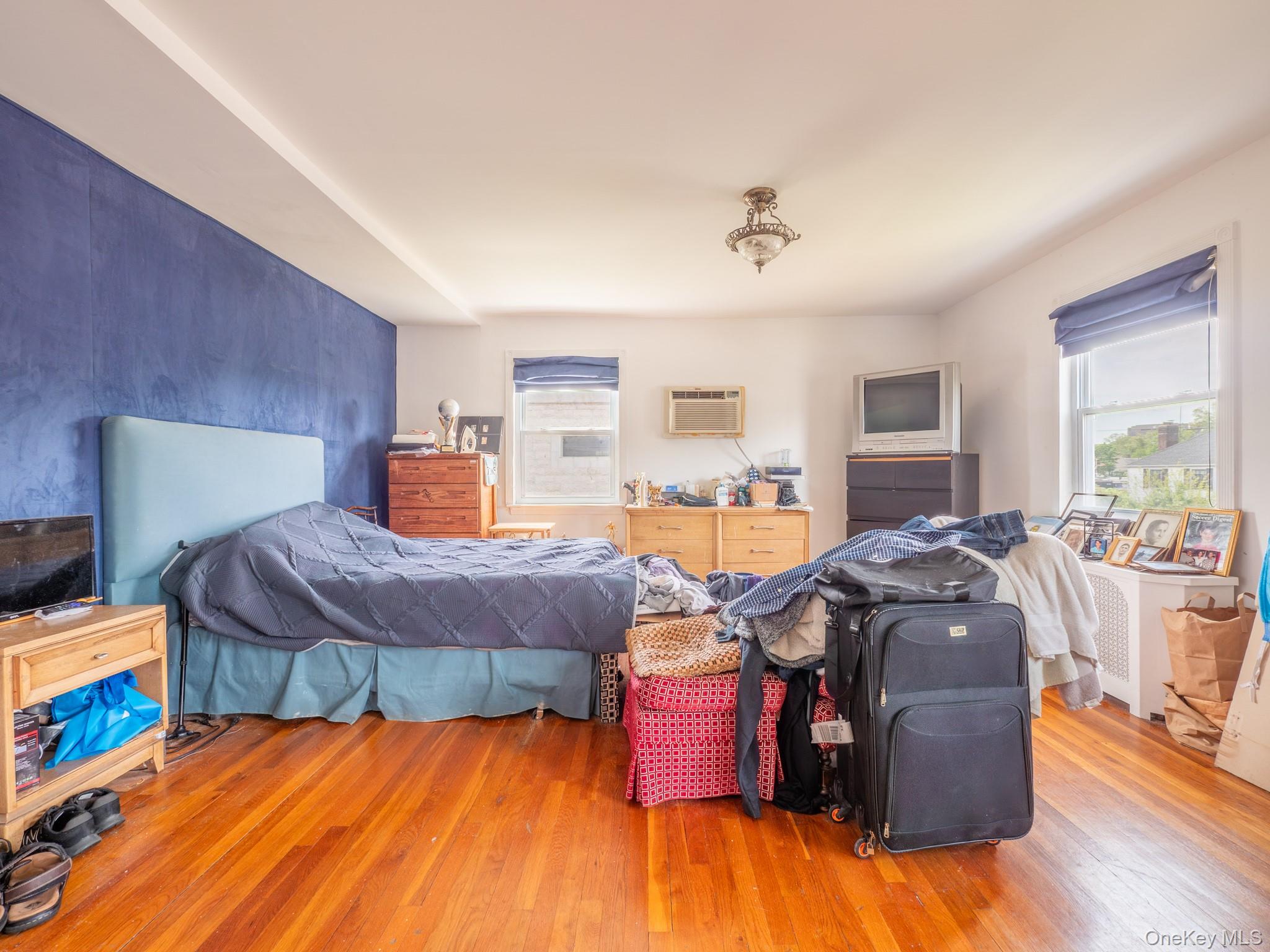 75-75 180th Street Queens, NY 11366 - Photo 47 of 48 a bedroom with furniture and wooden floor