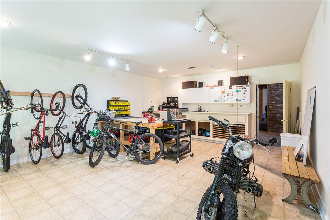 11809 Appaloosa Run East Raleigh, NC 27613 - Photo 25 of 30 This basement workshop/studio provides cabinets for storage, plenty of work space and both track and eyeball lighting. Basement Workshop/Studio