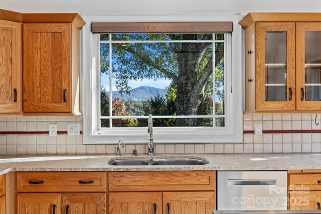 a large kitchen with stainless steel appliances granite countertop a sink and cabinets