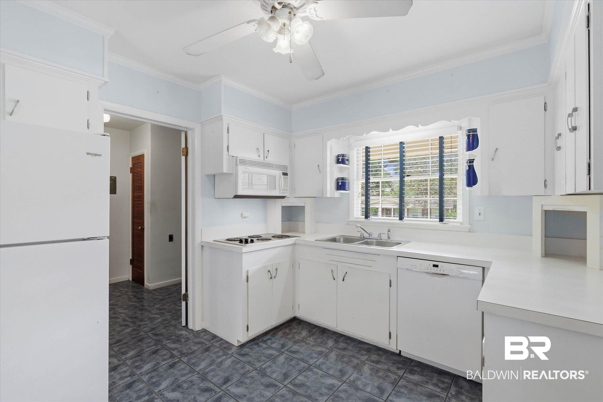 1182 Ginger Drive Mobile, AL 36693 - Photo 11 of 37 Kitchen featuring white cabinetry, a dual-basin stainless steel sink, a built-in microwave, an electric cooktop, and tile flooring