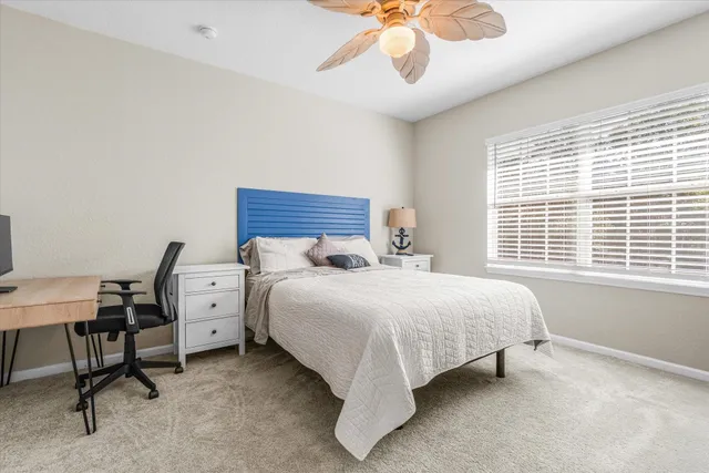 a spacious bedroom with a bed and a desk