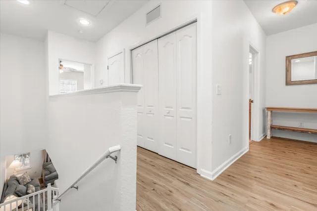 a view of hallway with wooden floor