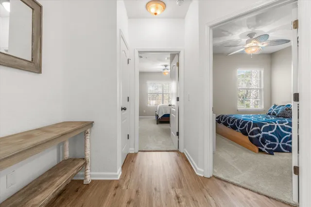 a view of a livingroom with wooden floor and staircase