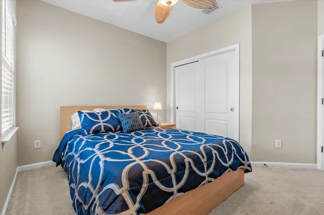 a bedroom with a bed and window