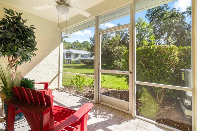 a view of a patio with table and chairs potted plants with wooden floor and fence