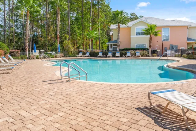 a view of a house with a yard and potted plants
