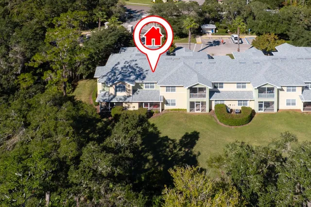 an aerial view of a house with a yard