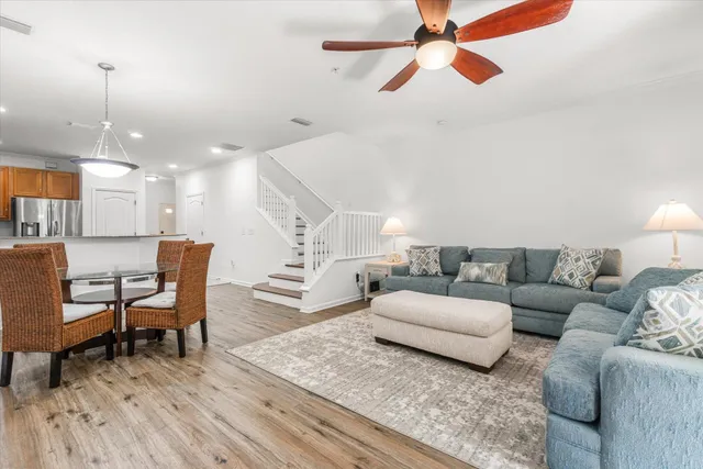 a living room with furniture and a wooden floor