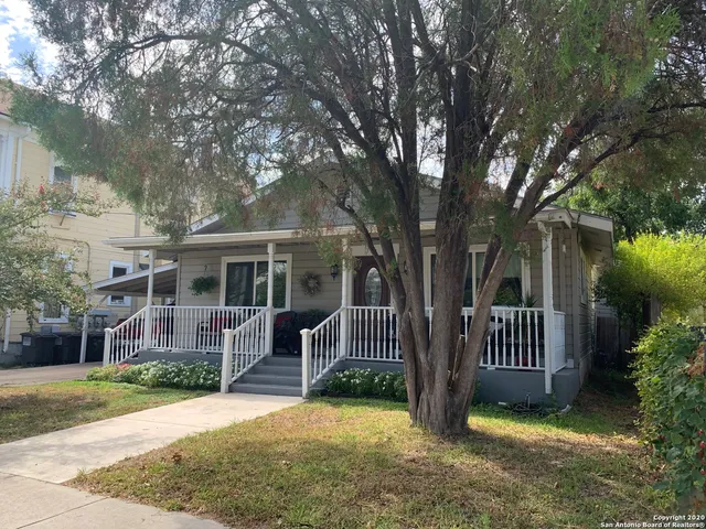 front view of a house with a yard and porch