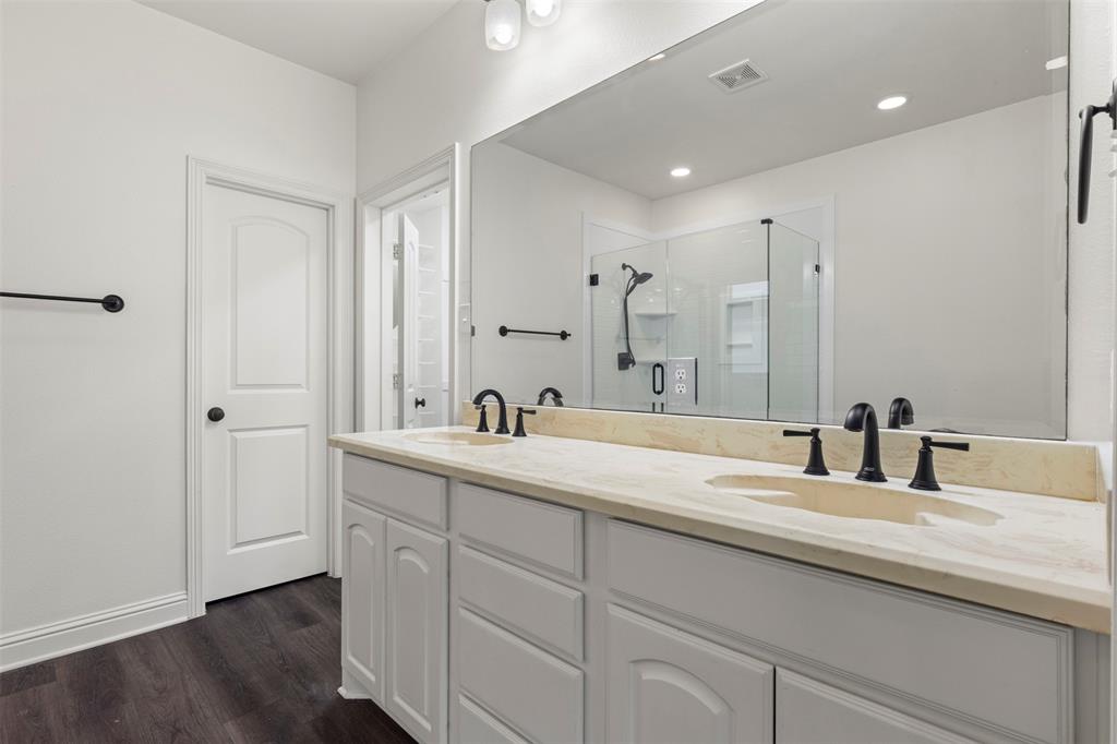 8813 Tudor Place Dallas, TX 75228 - Photo 15 of 27 a bathroom with a double vanity sink and mirror