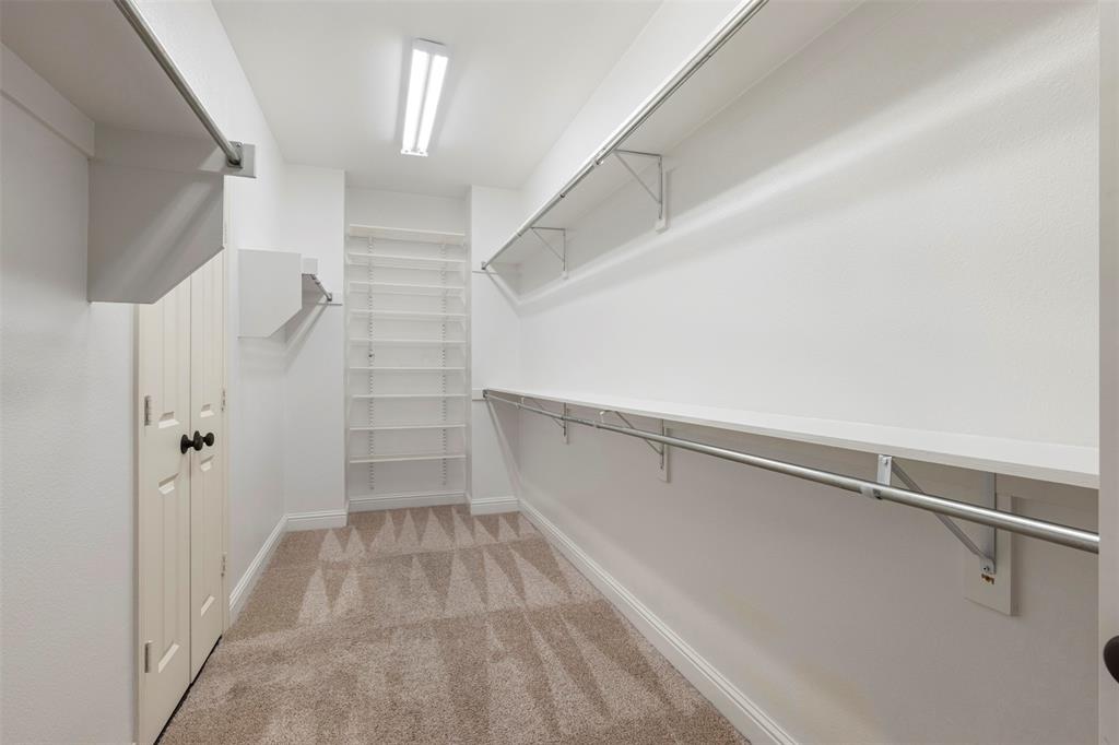 8813 Tudor Place Dallas, TX 75228 - Photo 16 of 27 a view of walk in closet with empty racks