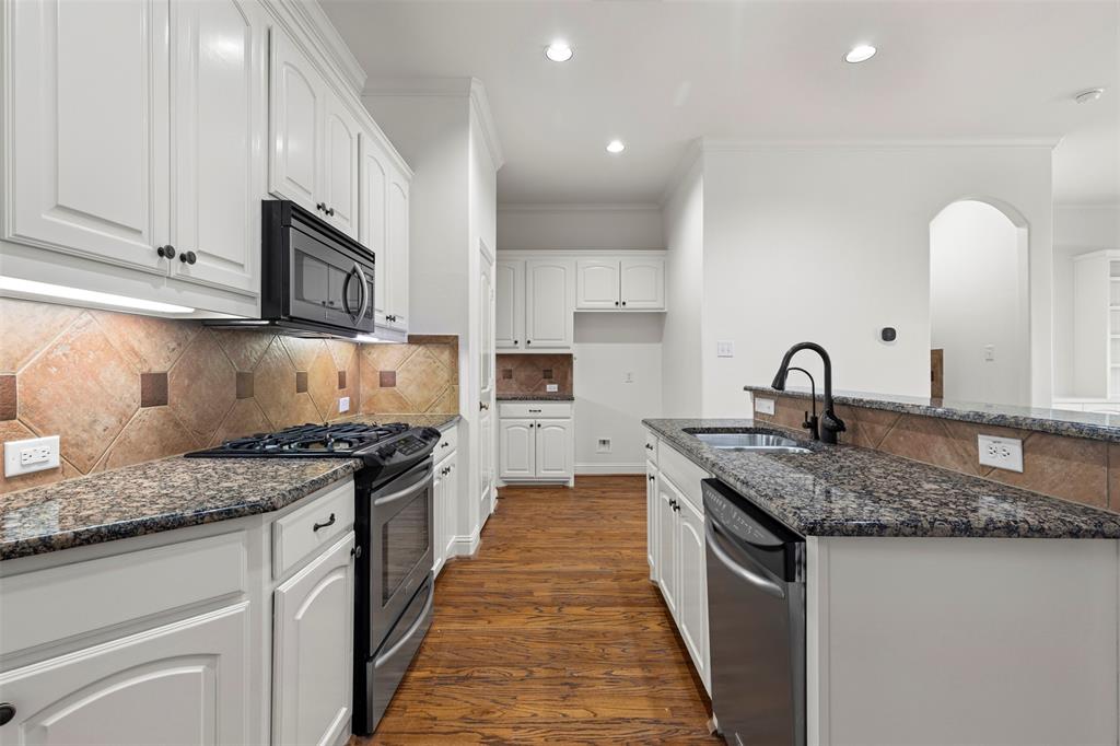 8813 Tudor Place Dallas, TX 75228 - Photo 10 of 27 a kitchen with granite countertop a sink and cabinets