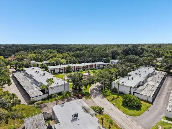 an aerial view of residential houses with outdoor space and pool