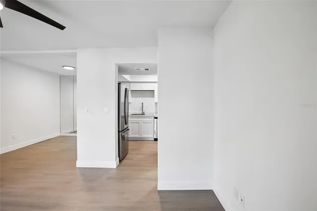 a view of a hallway with wooden shelves