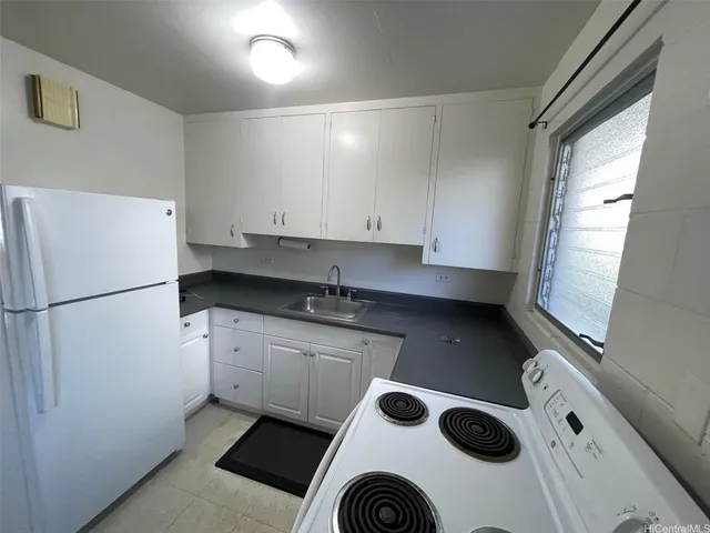 a kitchen with a refrigerator and a sink