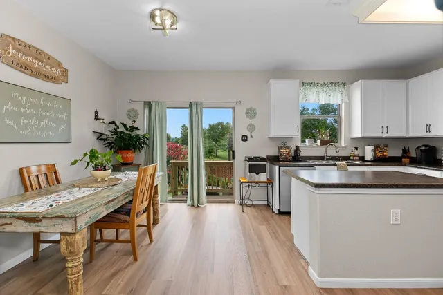 a kitchen with kitchen island granite countertop a sink a stove top oven a counter space and cabinets