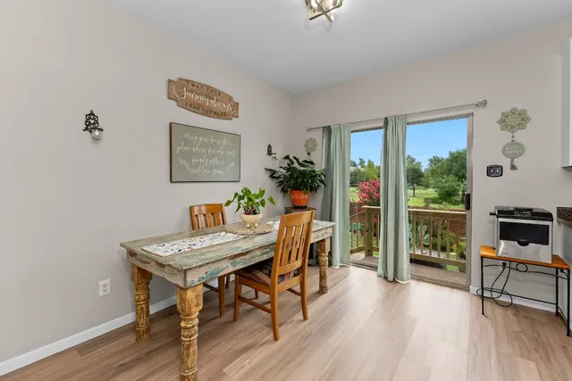 a kitchen with granite countertop white cabinets and stainless steel appliances