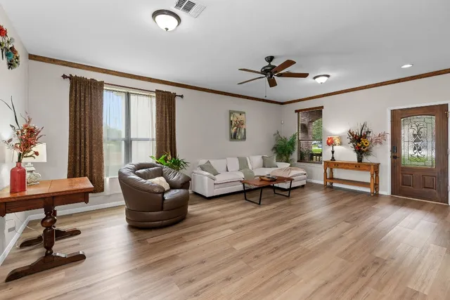 a view of room with wooden floor and stairs