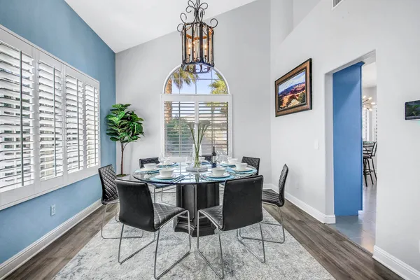 a kitchen with granite countertop a table and chairs in it