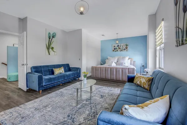 a spacious bathroom with a granite countertop double vanity sink and a mirror