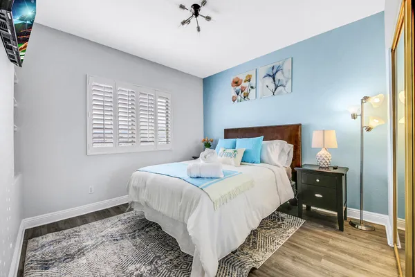 a bedroom with furniture and a chandelier