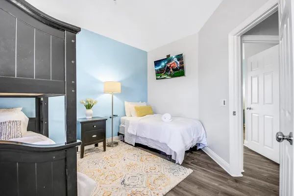 a bathroom with a granite countertop sink a mirror and a shower