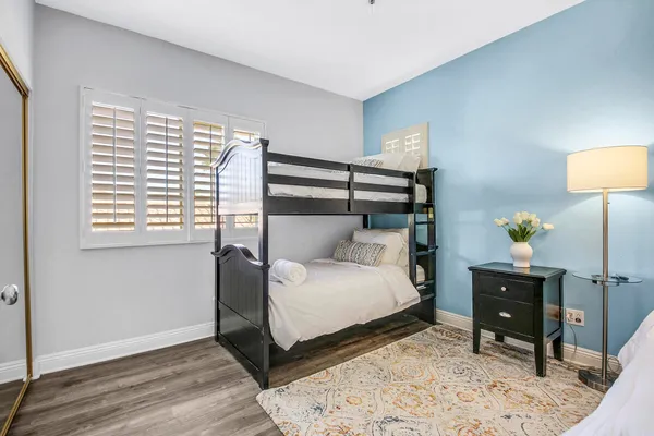 a view of a patio with table and chairs potted plants and large windows