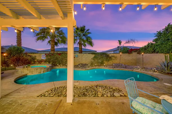 a view of a chairs and table in patio with a fire pit