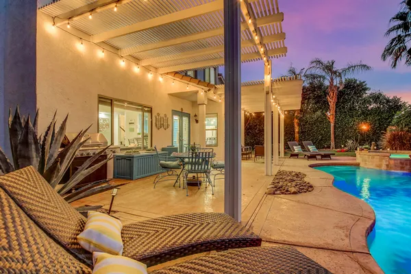 a front view of a house with backyard and sitting area