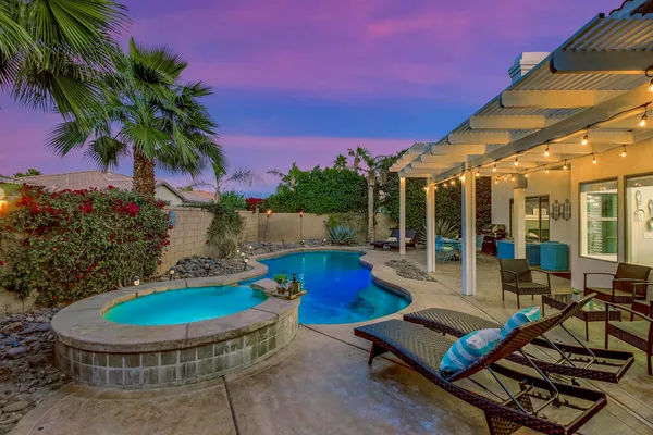 a view of a patio with table and chairs potted plants with wooden floor